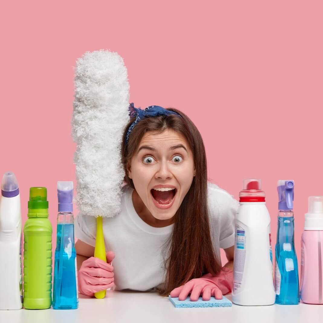 Excited woman cleaning with new products and duster, showcasing innovative cleaning solutions for home care.
