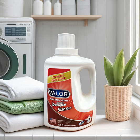VALOR Original Scent Laundry Detergent bottle beside freshly folded towels and a plant, showcasing cleanliness and freshness.