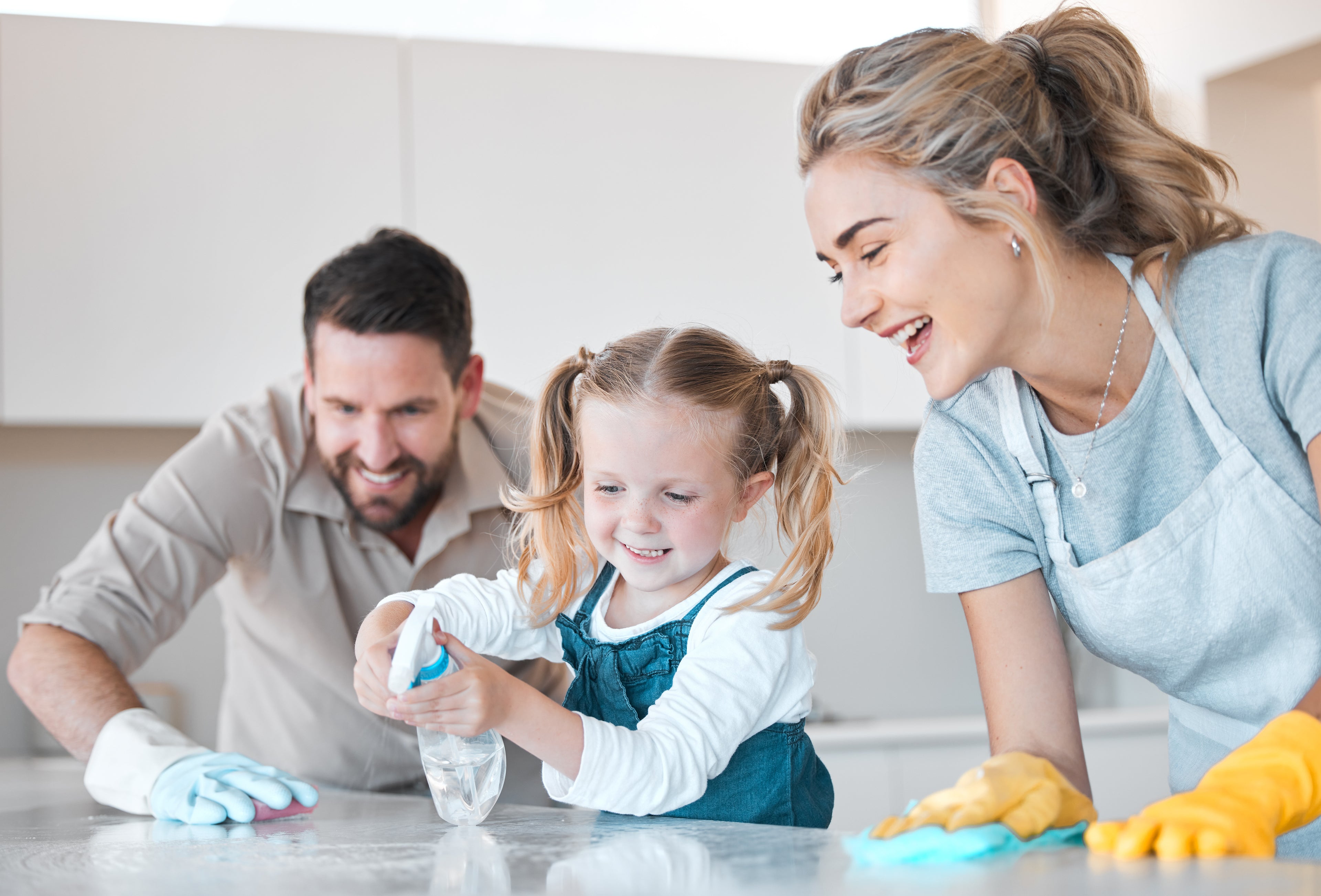 happy family cleaning together kitchen
