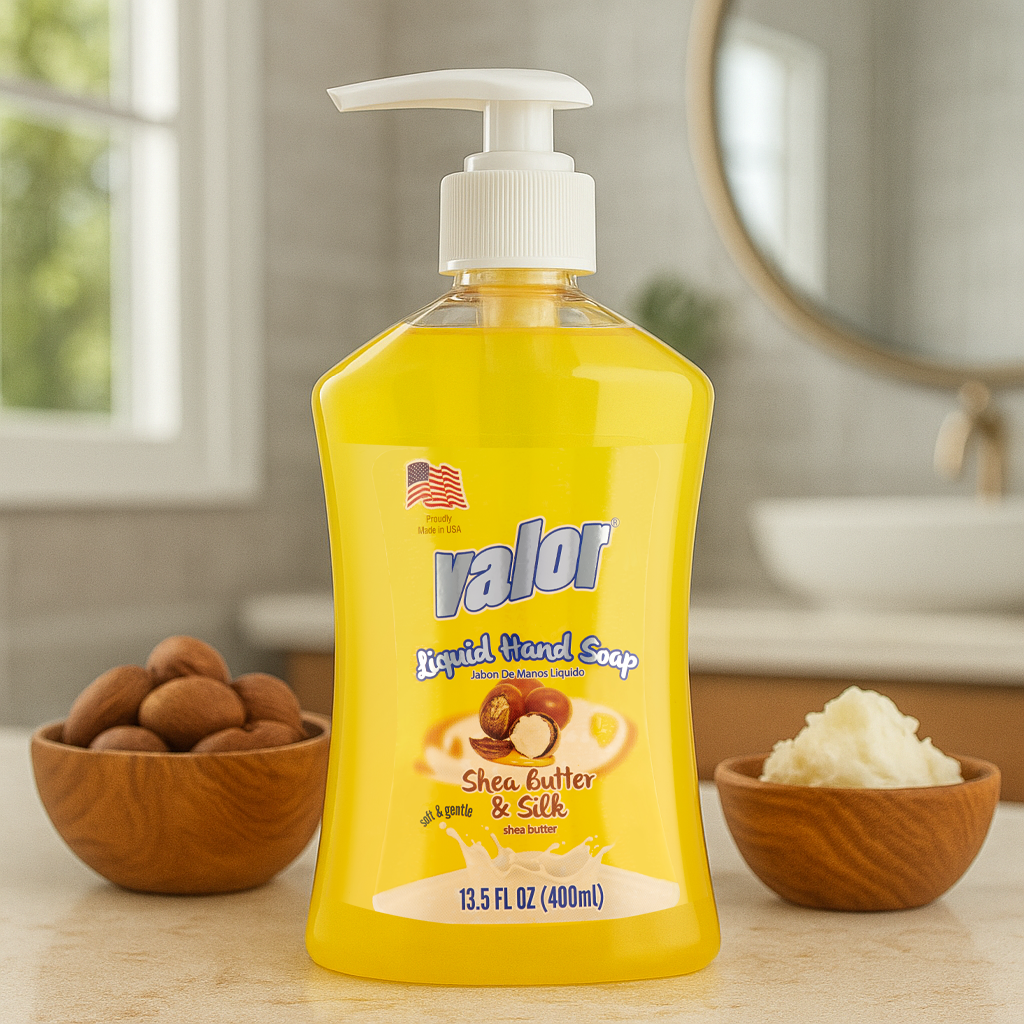VALOR Liquid Hand Soap with Shea Butter & Silk in a yellow pump bottle, surrounded by shea nuts and butter.
